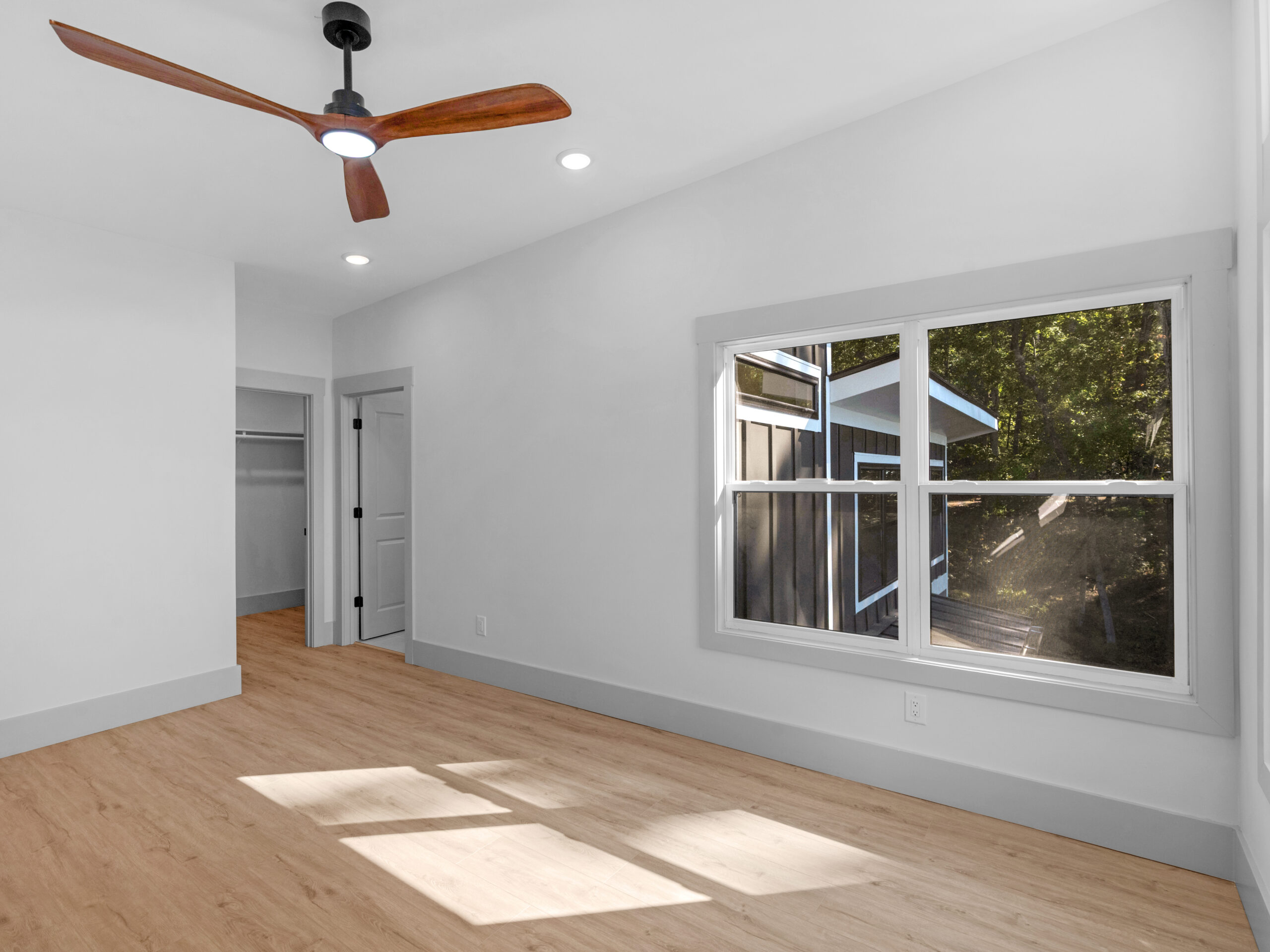 Newly built lake house with a finished walkout basement level on a sloped Georgia lot