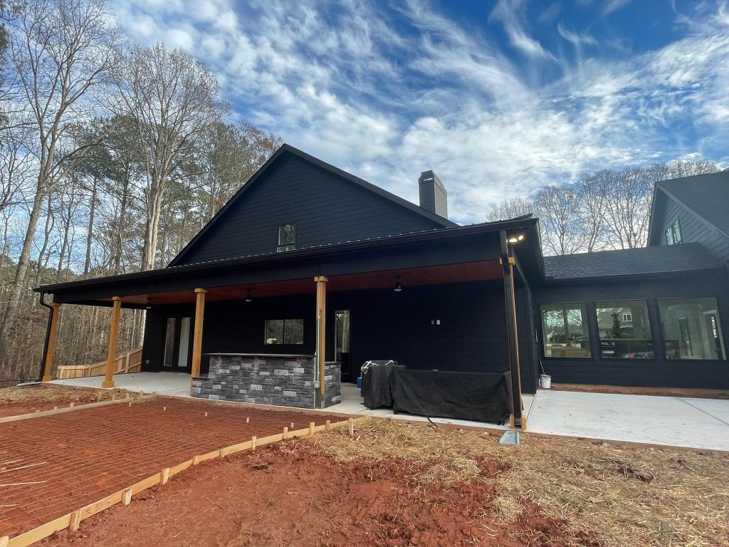 A house under construction with a brick patio
