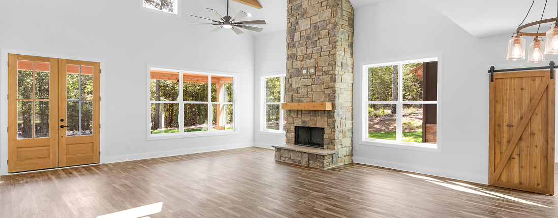 Barndominium great room with stone fireplace and barn door