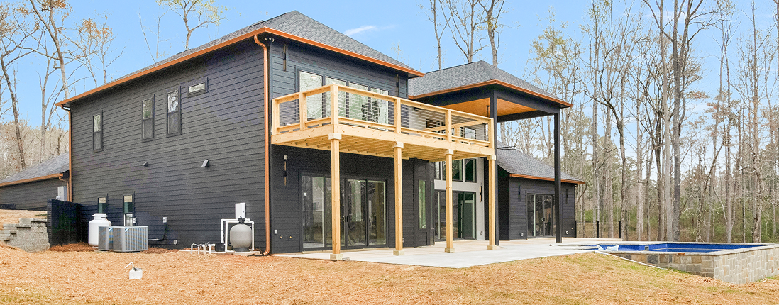 Barndominium open-concept loft with exposed staircase